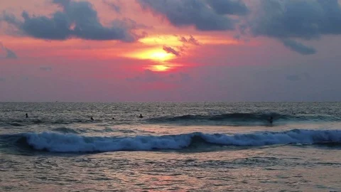 Evening surfers in the ocean Stock Footage 72475157