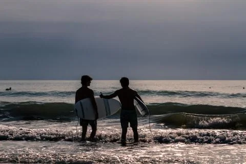 Evening surfers Stock Photos