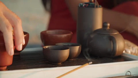 Evening tea ritual. Serene scene of two lovers performing peaceful tea ceremony Stock Footage 335632595