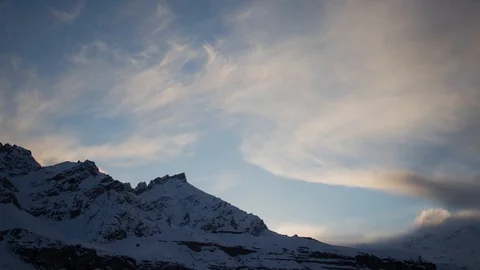 Evening time lapse of a beautiful sunset over the snow covered mountains Stockbeeldmateriaal 121949275
