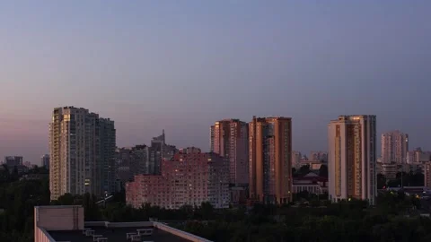 Evening time lapse in the city. It's getting dark, lights are on in the win.. Stock Footage 255042255