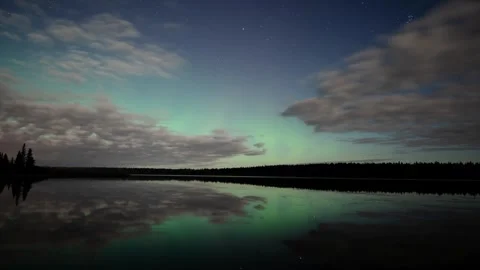 Evening time lapse video of a starry night with clouds moving over a lake Stock Footage 252327797