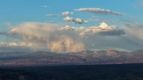 Evening Timelapse of a Storm Cloud Raining Over a Mountain Range Stock Footage 336949383