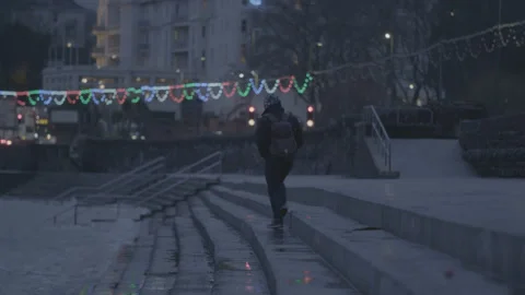 Evening in Torquay. Person walking down steps walking along water edge. Stock Footage 179516938