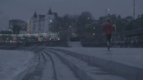 Evening in Torquay. Runner on coastline. Stock Footage 179457265