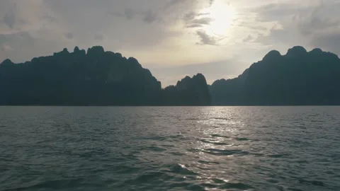 Evening Toss Boat Floating with View Mountain in Ratchaprapha Dam National Park Stock Footage 154016852