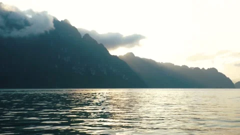 In Evening Toss Boat Floating with View Mountain in Dam National Park Stock Footage 154016906