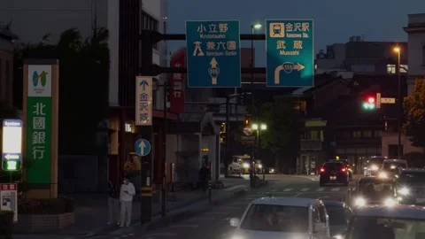 Evening Traffic and Direction Signs on Urban Street Near Kanazawa Station, Japan Stock Footage 341373344