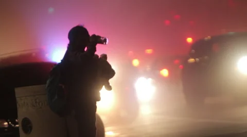 Evening traffic with headlights through intersection Stock Footage 46804017