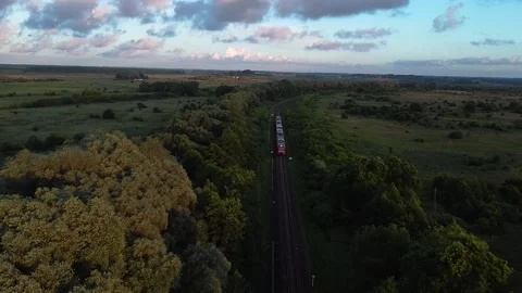 Evening train arrives at a small station, drone view Stock Footage 201066403