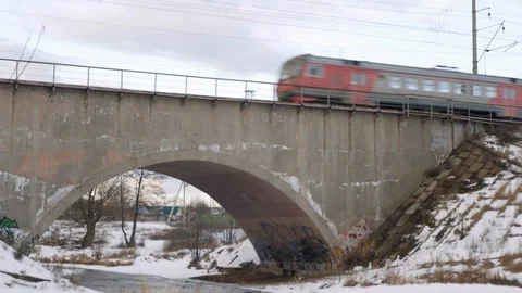 Evening train passes over a bridge over a river Stock Footage 124743962