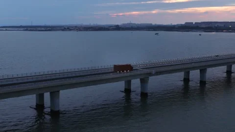 Evening twilight drone shot of Qingdao cross-sea highway, moving traffic and 库存影片 341379554