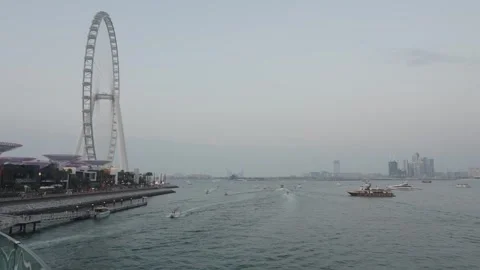 Evening view of the bay and the Ain Dubai Ferris wheel and floating boats Stock-Footage 331728418