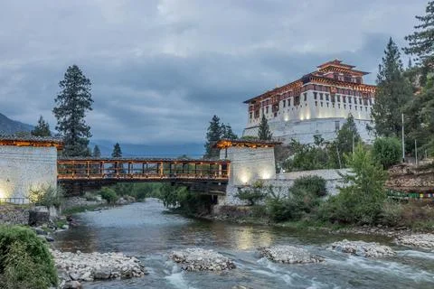 Evening view of  a bridge over Paro river to Rinpung Dzong, Buddhist monaster Stock Photos