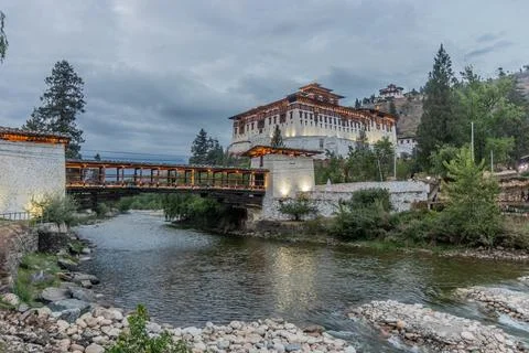 Evening view of  a bridge over Paro river to Rinpung Dzong, Buddhist monaster Stock Photos
