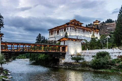 Evening view of  a bridge over Paro river and Rinpung Dzong, Buddhist monaste Stock Photos
