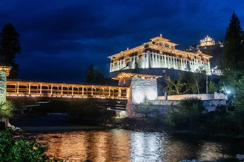 Evening view of  a bridge over Paro river to Rinpung Dzong, Buddhist monaster Stock Photos