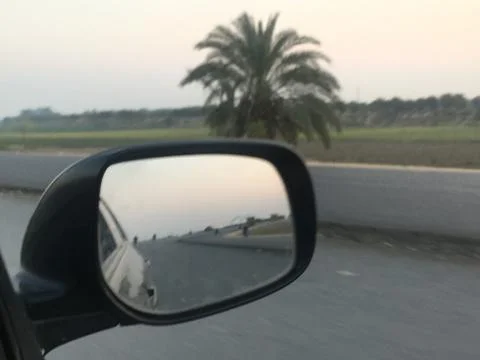 Evening view in car mirror Stock Photos