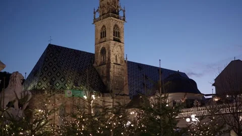 Evening View Of Cathedral With Patterned Roof And Tree, Bolzano, Italy Stock Footage 329321176