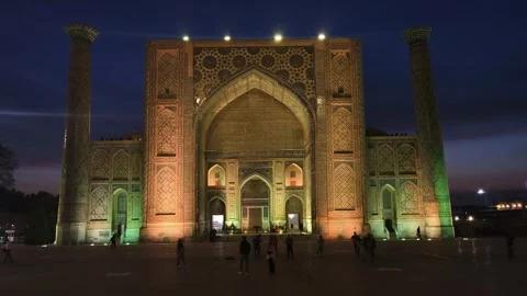 Evening view of grand illuminated facade Ulugbek madrasah in Registan Square  Stock Footage 331060780