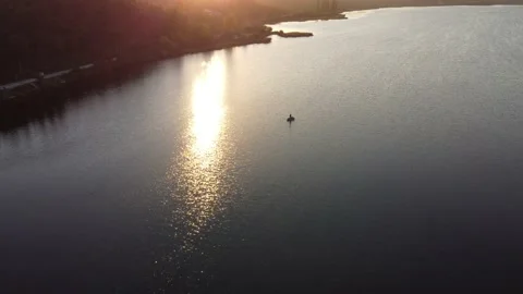 Evening view of the lake at sunset which reflects the rays on the water. Silhoue Stock Footage 162738909
