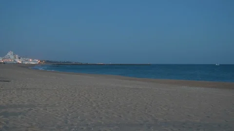 Evening view looking across the sandy beach as sun sets Stock Footage 106497534