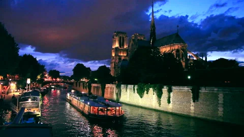 Evening View of Notre-Dame Cathedral from a Seine River Cruise Stock Footage 332457327
