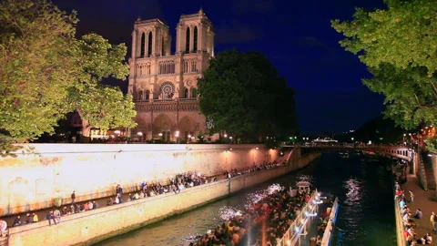 Evening View of Notre-Dame Cathedral from a Seine River Cruise Stock Footage 332457347
