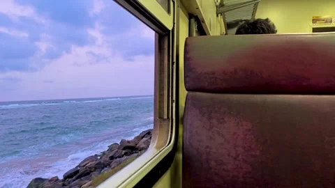 Evening view of an old train passing through coastal railway. 4K 库存影片 328427973