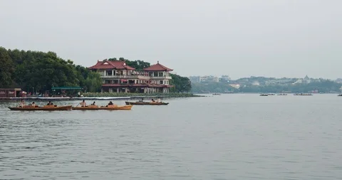 Evening view of paddle boats on West Lake in Hangzhou, China Stock Footage 118441946