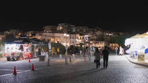 Evening view of people walking along the bustling port of Naoussa in Paros Stock Footage 295174044