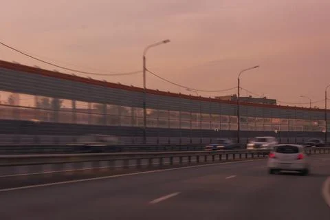 Evening view of a road in orange light. The effect of speed on the road 스톡 사진
