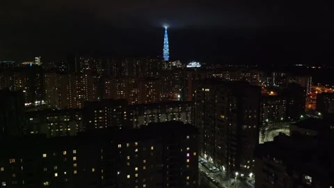 Evening view of a sleeping area with a skyscraper on the outskirts Stock Footage 141441400