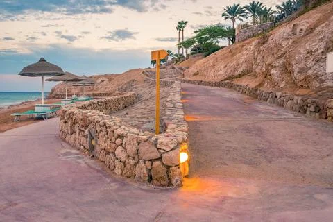 Evening view for a small road on beach in illumination Stock Photos