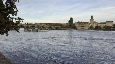 Evening View of the Vltava River with Pleasure Boat and Charles Bridge Stock Footage 289370119