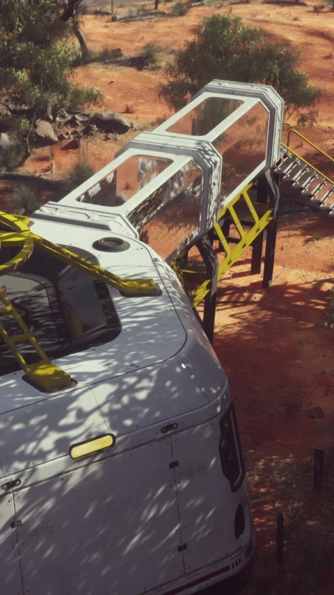 Evening view of a white camper and a glass structure in the outback Video stock 342615400