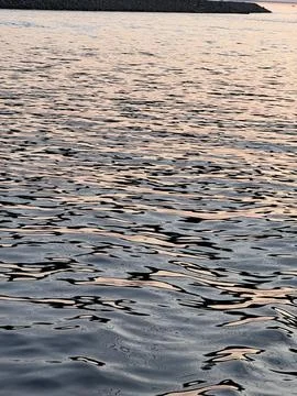 Evening Water Waves Reflecting Subtle Pink Sky Stock Photos