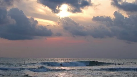Evening wave surfers Stock Footage 72474180
