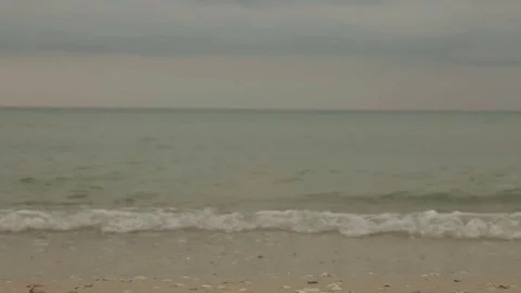 Evening waves with foam on a sandy beach Stock Footage 81070699