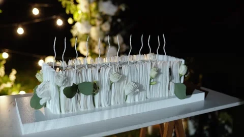 Evening wedding arch of white flowers. Large white cake with cream Video stock 327409934