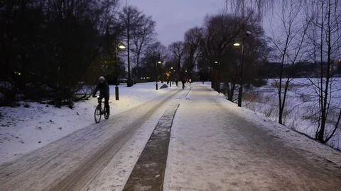 Evening winter street in Helsinki and cyclist Stock Footage