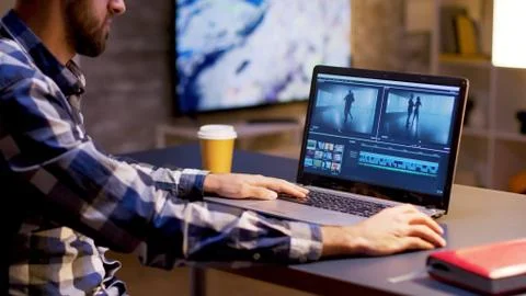 In the evening young content creator working multimedia project Stock Photos
