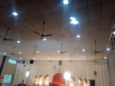 Event Hall Interior with Ceiling Fans and Lighting Stockfoto's