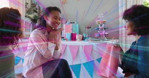 Event host handing pink gift bag on patio for occasion, confetti swirling as Stock Footage 318140004