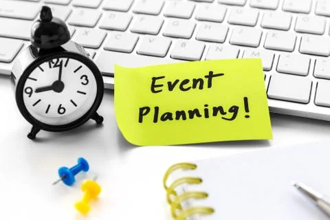 Event planning word on notepad with clock on white computer desk Stock Photos