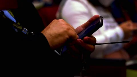 Event stuff manager with superior tag uses mobile phone to coordinate team Video stock 205587172