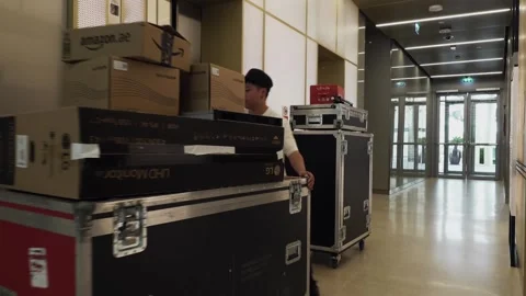 Event technician pulling cases on a lift for a show Stock Footage 244787971