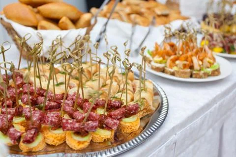 Event with various appetizers on a table with a white tablecloth Stock Photos