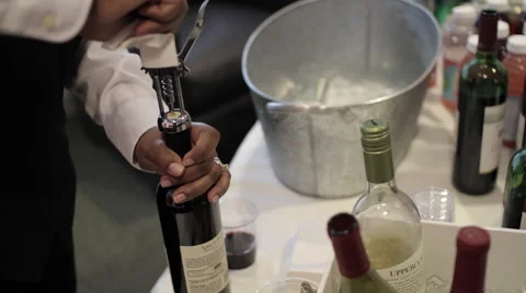 Event Wine Pour | Bartender uncorks wine bottle and pours Stock Footage 50005124