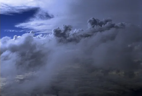 An ever-changing flight over, below, and through an expansive cloud bank shows Stock Footage 86832326